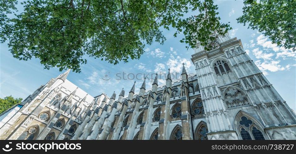 Westminster Abbey surrounded by trees, London in summer, UK