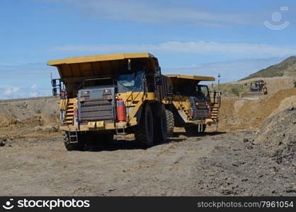 WESTPORT, NEW ZEALAND, MARCH 11, 2015: 130 ton loads of rock overburden are carried away at the Stockton open cast coal mine on March 11, 2015 near Westport, New Zealand