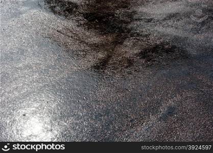 Wet asphalt background. Wet asphalt background with reflections of the sun during a day after heavy rain