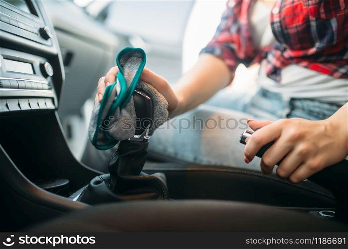 Wet cleaning of the car interior on car-wash. Woman on self-service automobile wash. Outdoor vehicle cleaning at summer day