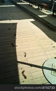 Wet footsteps on decking in St Maxime on the French Riviera