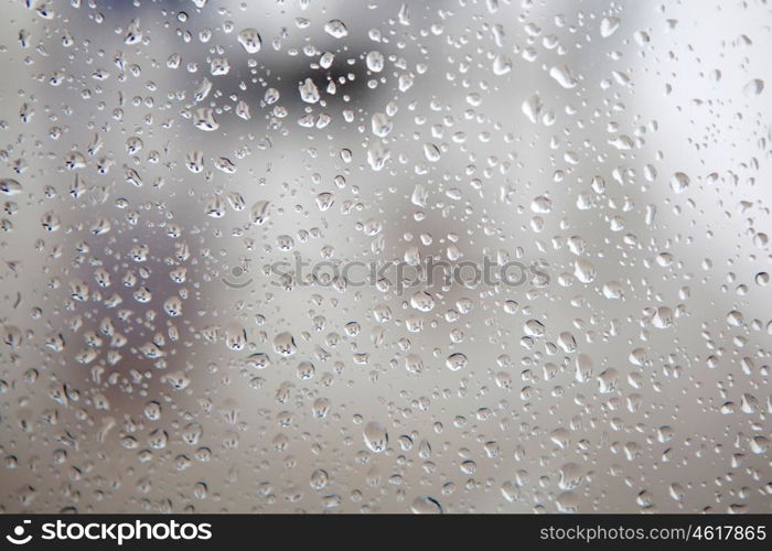 Wet glass with drops of rain fall on the street