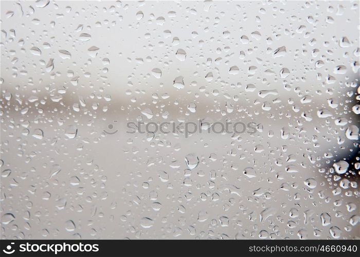 Wet glass with drops of rain fall on the street, &#xA;