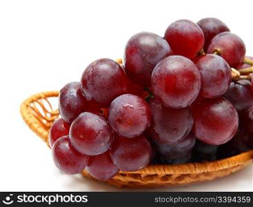 wet grape berry bunch in basket isolated on white