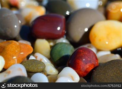 Wet multi-colored pebbles on the beach