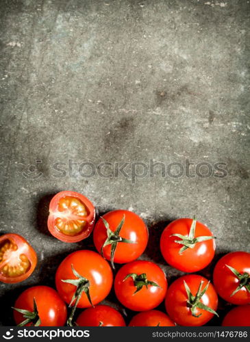 Wet red tomatoes on the stone table.. Wet tomatoes on stone table.