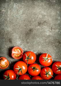 Wet red tomatoes on the stone table.. Wet tomatoes on stone table.