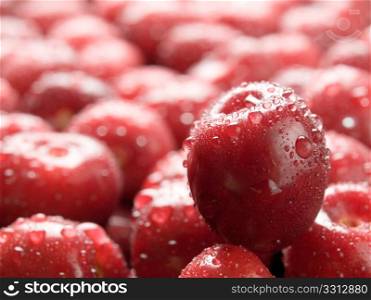Wet ripe cherry closeup background.