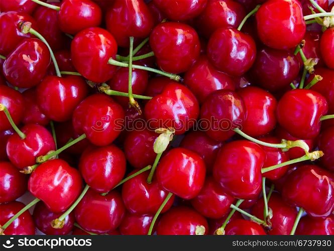 Wet ripe red cherries can use as background