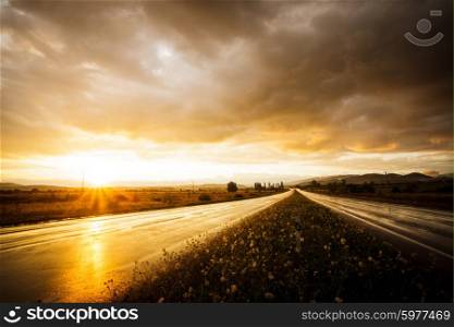 Wet road and sky. Wet road after rain and sunset over fields