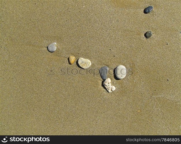 Wet sand background with sea pebbles