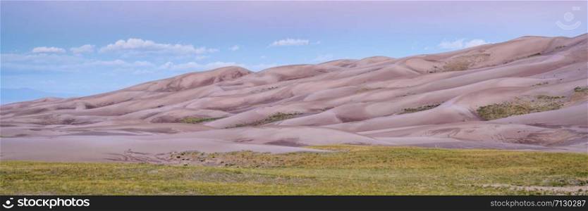 wet sand dunes patterns and texture at dawn - Great Sand Dunes National Park and Preserve in Colorado, panorama