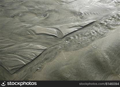 Wet sand patterns on beach, Pacific Rim National Park Reserve, Tofino, British Columbia, Canada