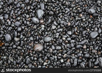 Wet sea pebbles on a beach close up