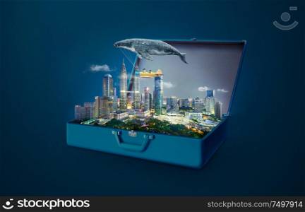 Whale floats in the sky and carrying a plane with two young little sister in an open retro vintage suitcase isolated on light blue background . Travel and vacation concept.