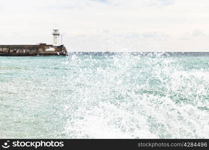 wharf with lighthouse in Yalta city in autumn day, Crimea