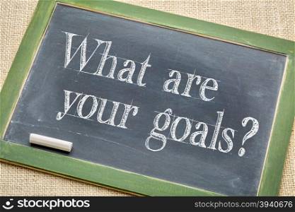 What are your goals? A question on a vintage slate blackboard with a white chalk against burlap canvas