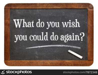 What do you wish you could to again? A question in white chalk text on a vintage slate blackboard