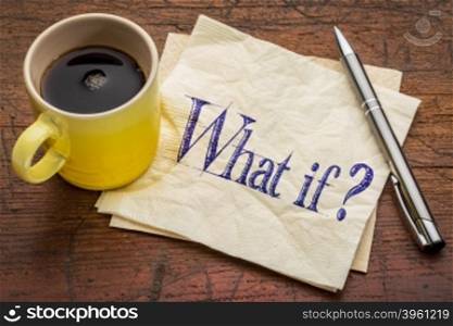 What if question - handwriting on napkin with a yellow cup of espresso coffee against rustic wood