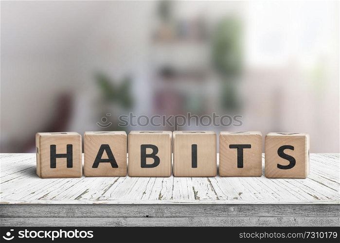 What is your habits  Sign with the word habits on a wooden desk in a bright room