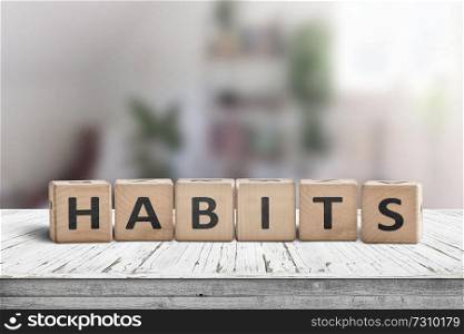 What is your habits  Sign with the word habits on a wooden desk in a bright room