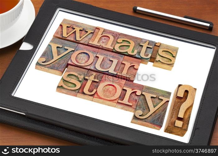 what is your story question in vintage wooden letterpress printing blocks on a digital tablet with a cup of tea