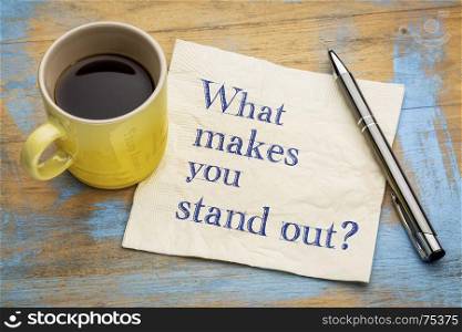 What make you stand out? Handwriting on a napkin with a cup of espresso coffee