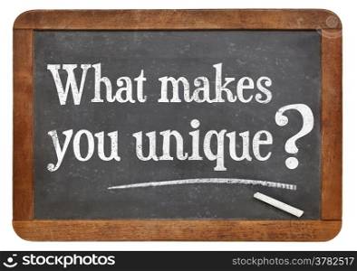 What makes you unique question on a vintage blackboard isolated on white