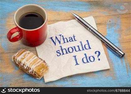 What should I do question - handwriting on a napkin with a cup of coffee