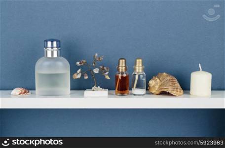 Whatnot and sundries on white shelf on blue wallpaper background
