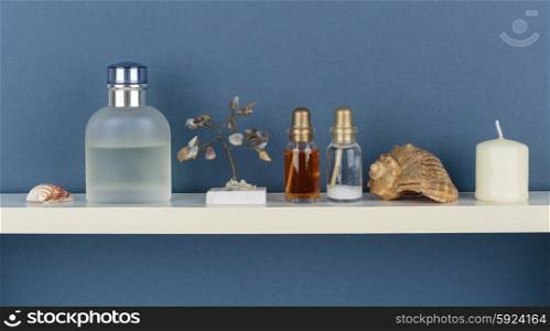 Whatnot and sundries on white shelf on blue wallpaper background