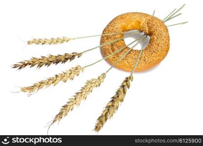 Wheat and bread on white background