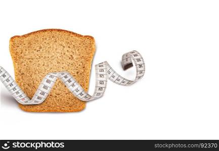 Wheat bread piece with the measuring tape on white background. Concept of health care.