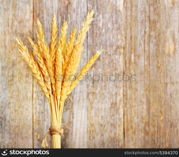 Wheat ears on a wood background