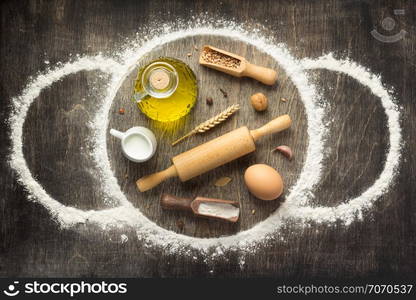 wheat flour and bakery ingredients on wooden background, top view