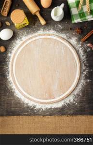 wheat flour and cutting board on wooden background, top view