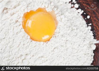 Wheat flour and egg yolk in a clay plate