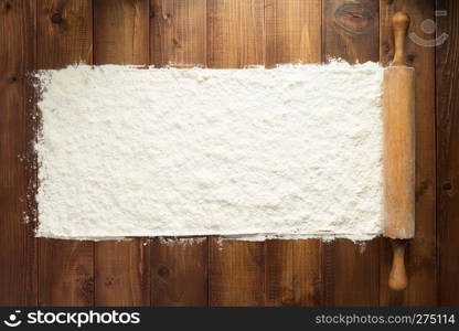 wheat flour on wooden background, top view