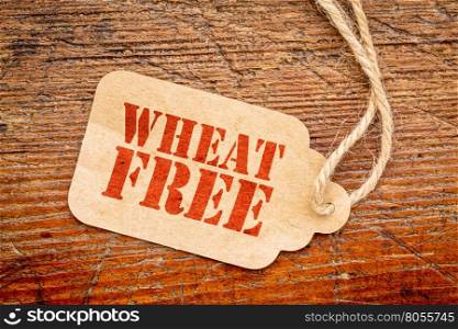 wheat free sign - a paper price tag against rustic red painted barn wood - gluten free healthy eating concept