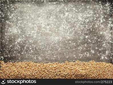 wheat grains at wooden background, top view