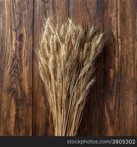 wheat on wooden background. top view