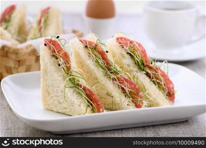 Wheat toast sandwich  with cream cheese with microgreen onion sprouts and salami. Healthy and fresh food.