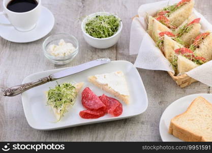 Wheat toast sandwich  with cream cheese with microgreen onion sprouts and salami. Healthy and fresh food.