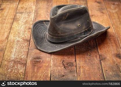 wheathered outback hat on rustic red barn wood