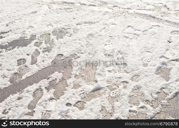 wheel and foot prints in the fresh snow