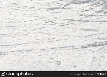 wheel and foot prints in the fresh snow