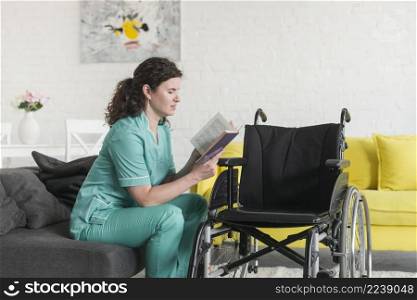 wheel chair front nurse sitting sofa reading book
