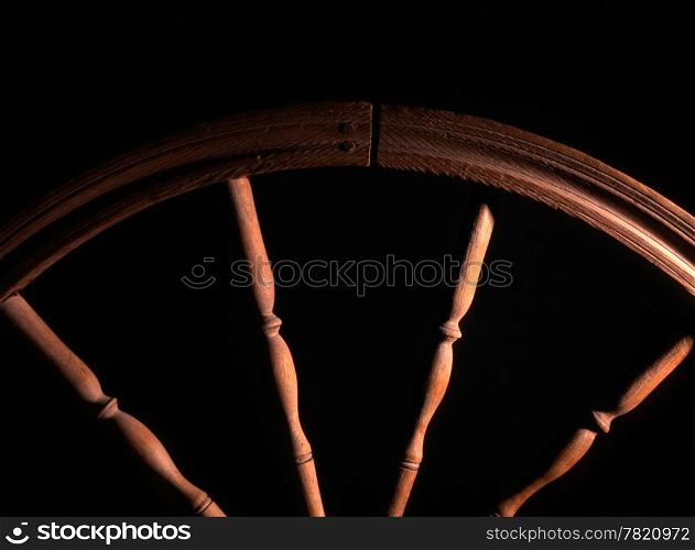 wheel of vintage wooden spinning closeup in dark