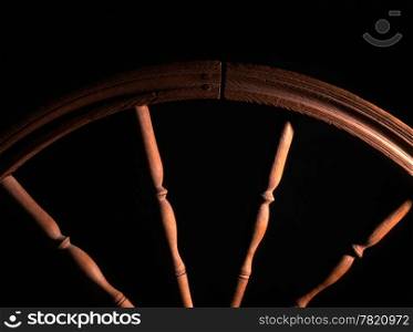 wheel of vintage wooden spinning closeup in dark