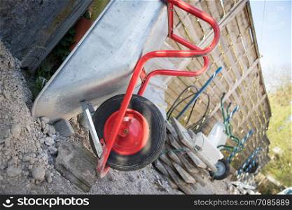 Wheelbarrow on a construction site, outdoors. Concept for renovation and construction